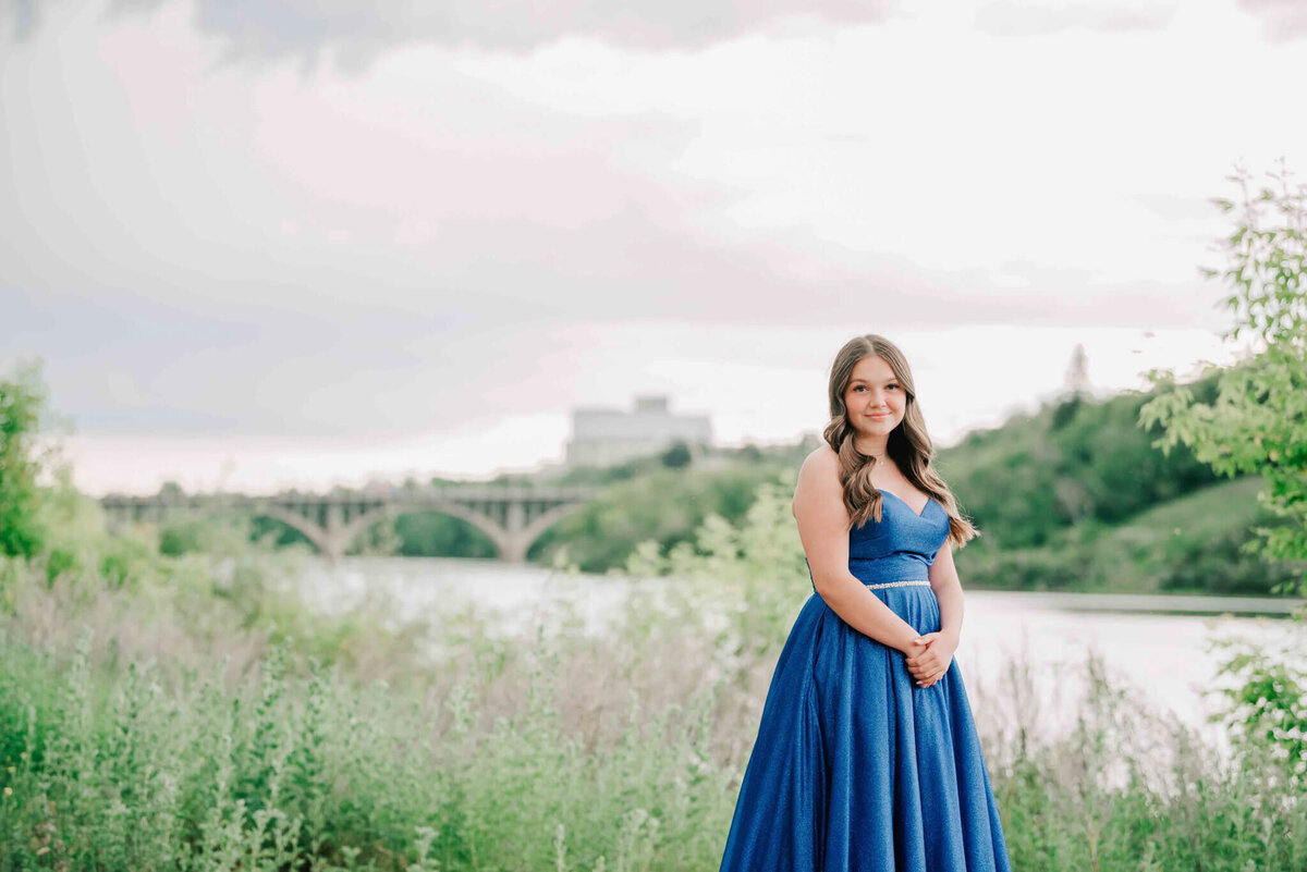 Further away portrait of a girl in a  blue dress. 