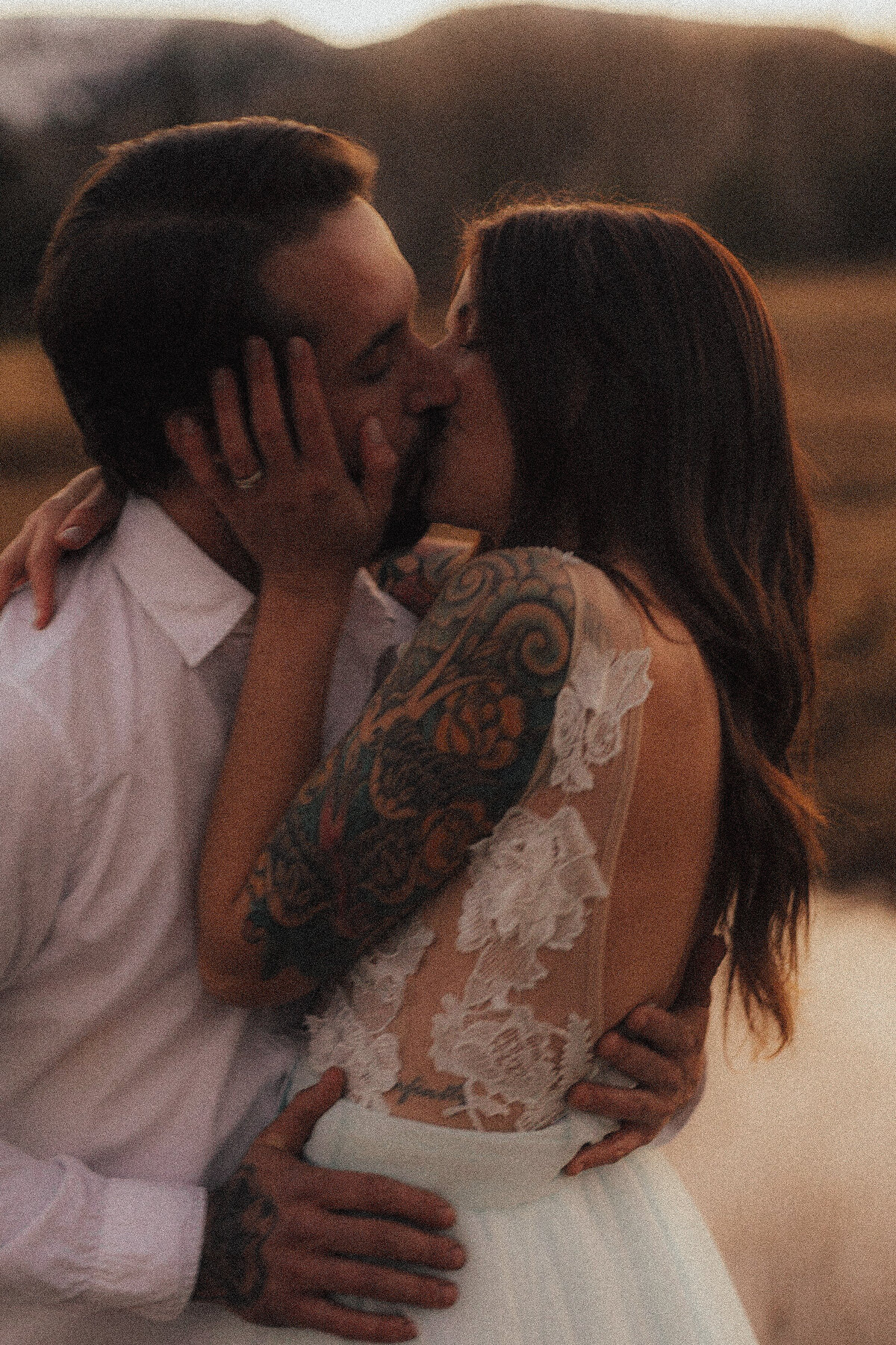 Couple kisses in filmy cinematic embrace at tree creeks Sisters elopement