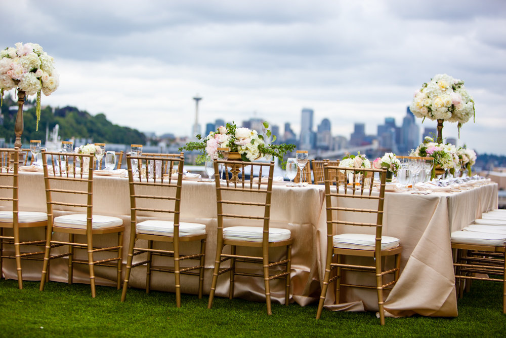 Outdoor wedding reception on the lawn with stunning Seattle views and romantic floral.