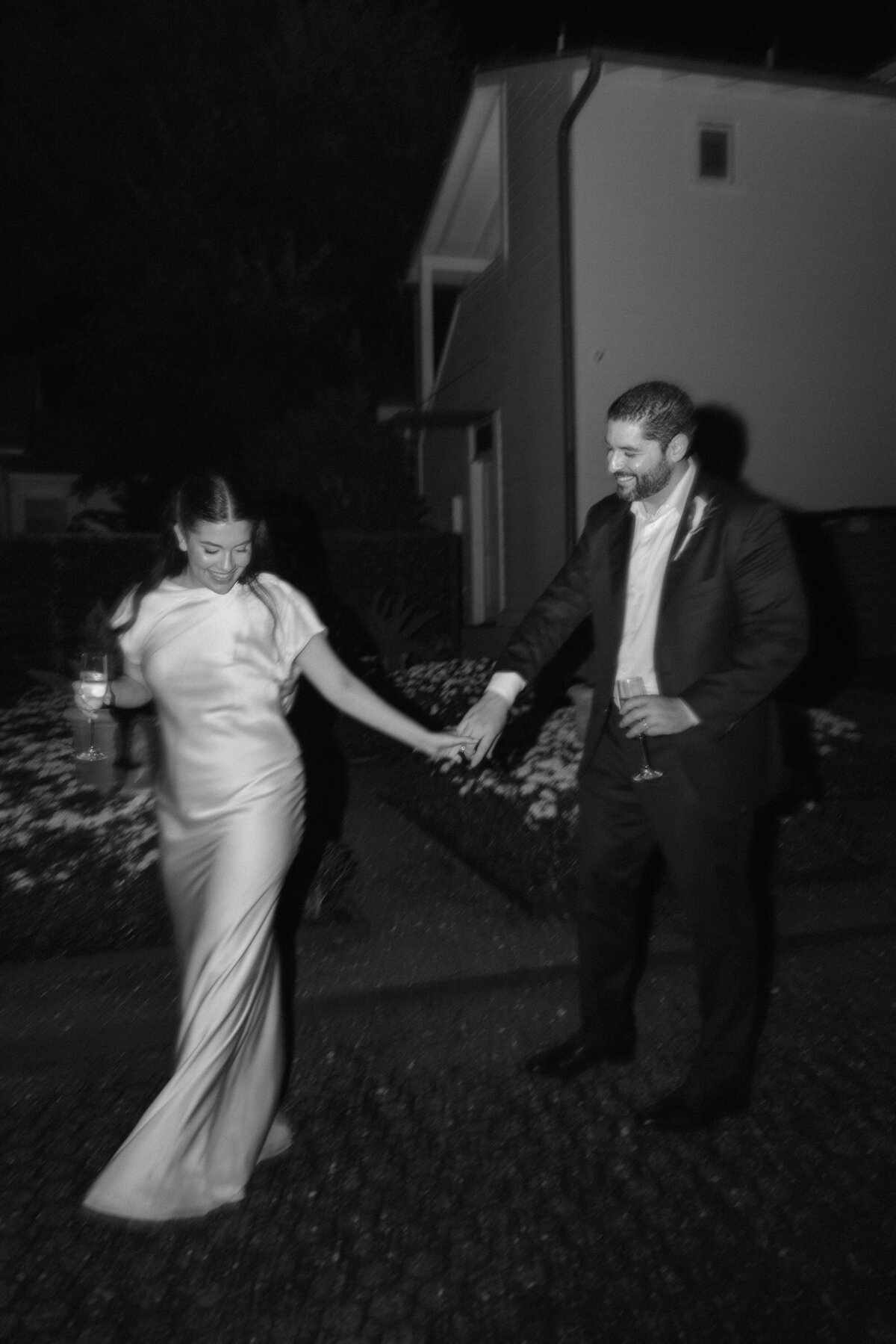 bride and groom black and white photo of them dancing