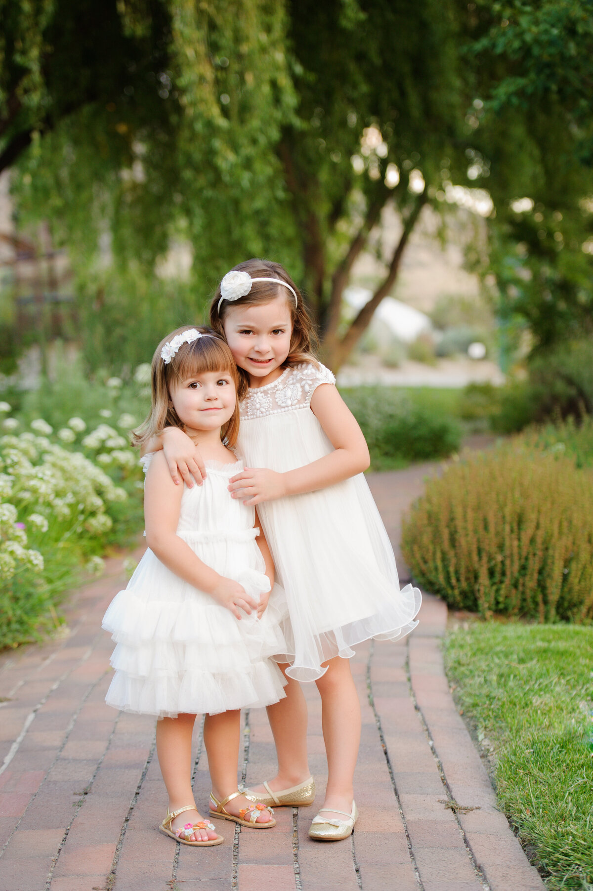 Sisters standing together at the Idaho Botanical Gardens in Boise.