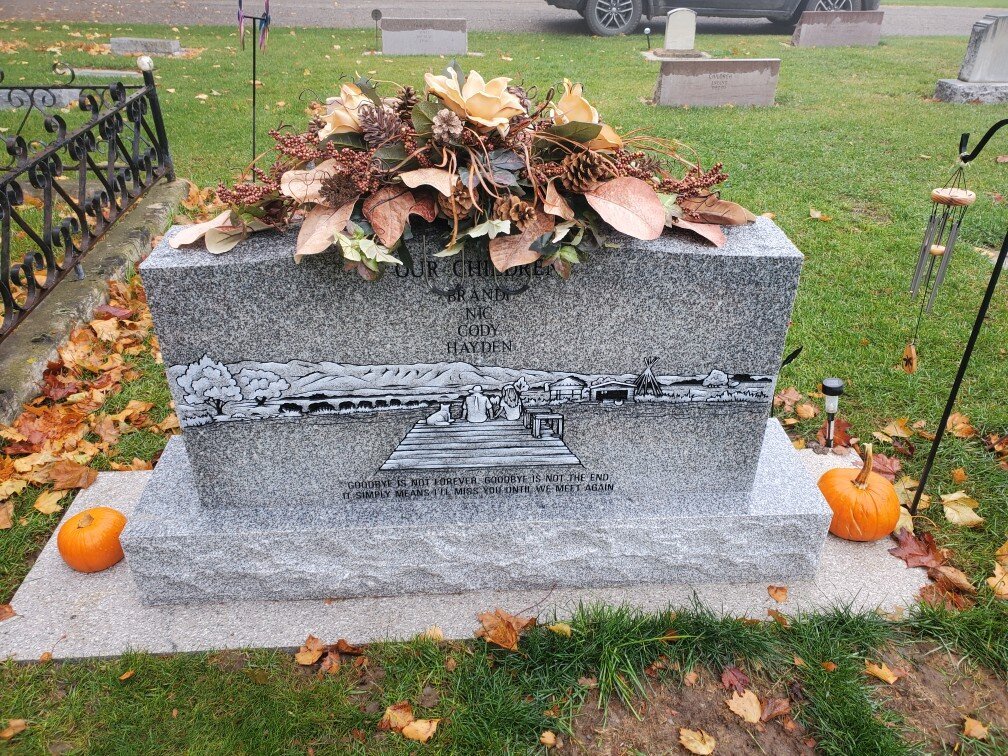 silk arrangement for the top of a headstone for the fall season