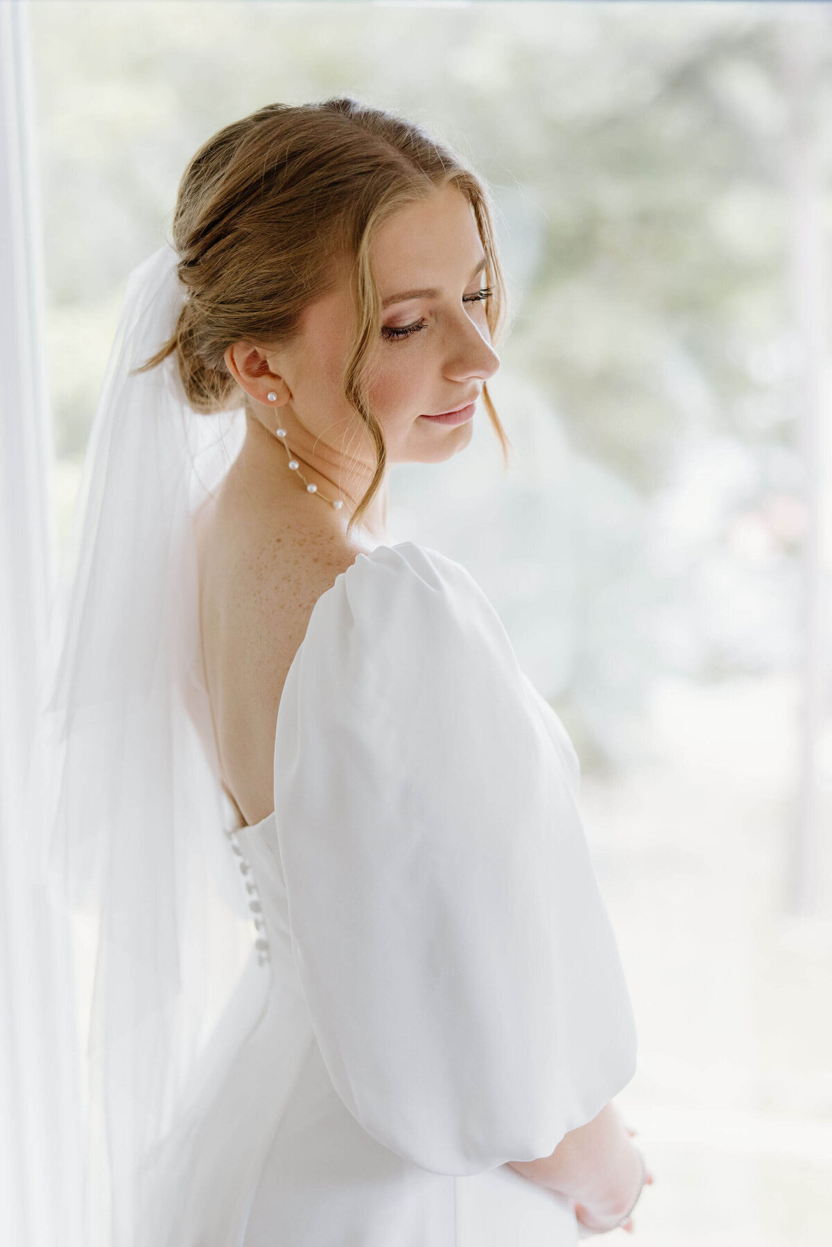 bridal portrait of bride in traditional white wedding gown and veil