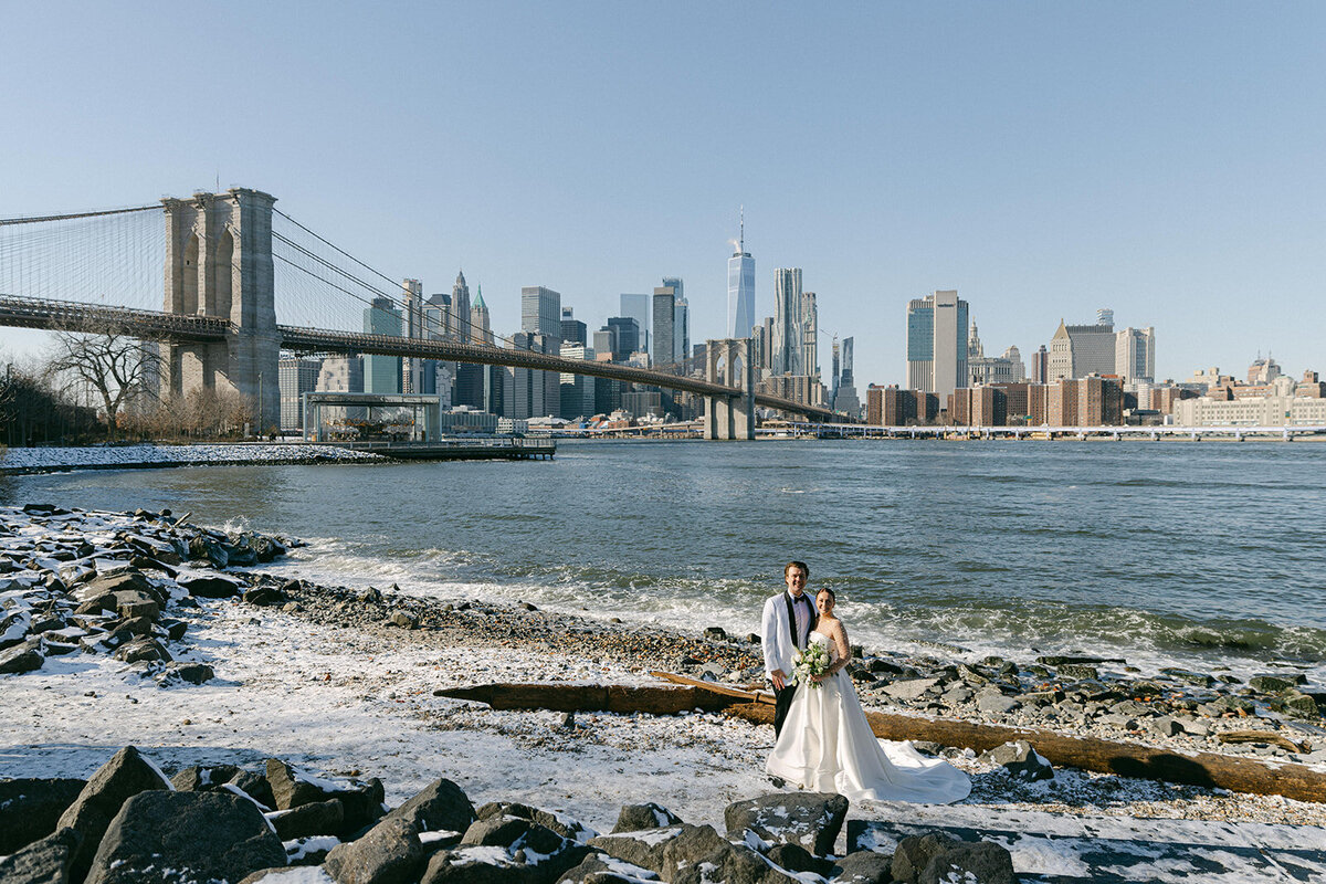 A wedding couple beneath the Brooklyn Bridge