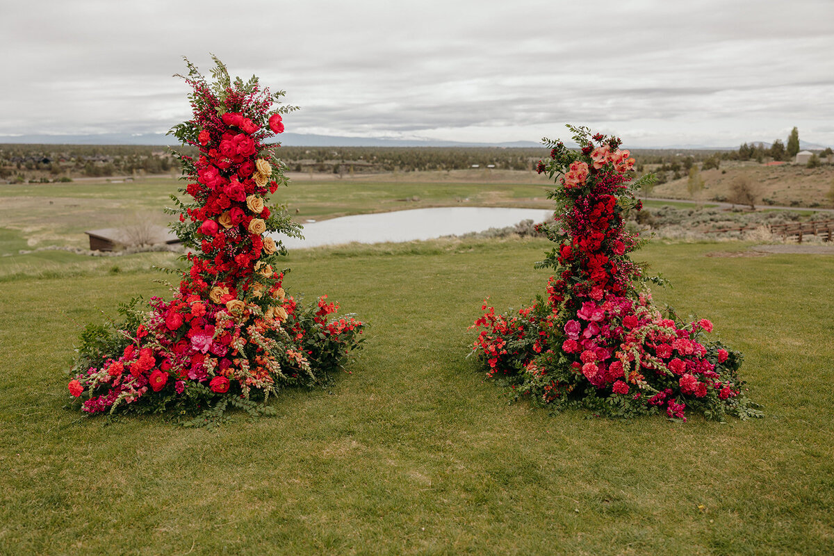 Colorful floral pillars at Brasada Ranch ceremony with mountain backdrop