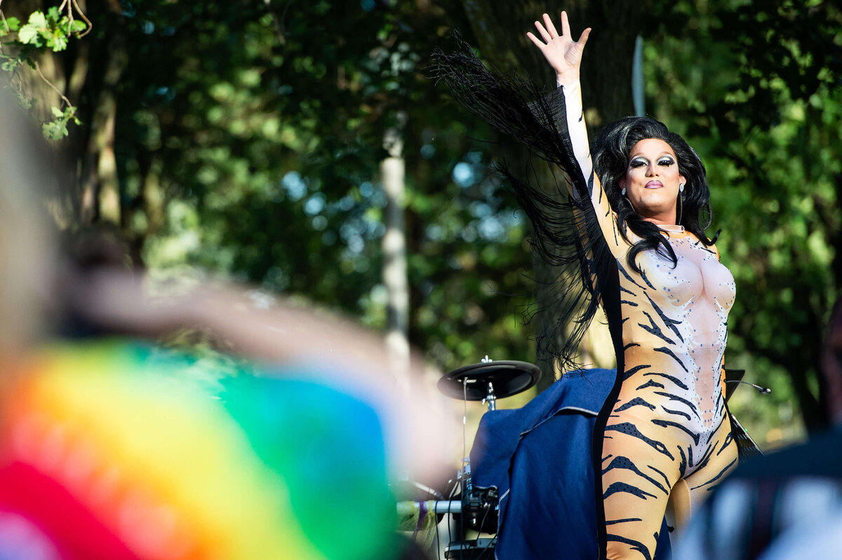a pride parade performer in a tiger suit dancing on stage.  Captured by Ottawa Event Photographer JEMMAN Photography COMMERCIAL