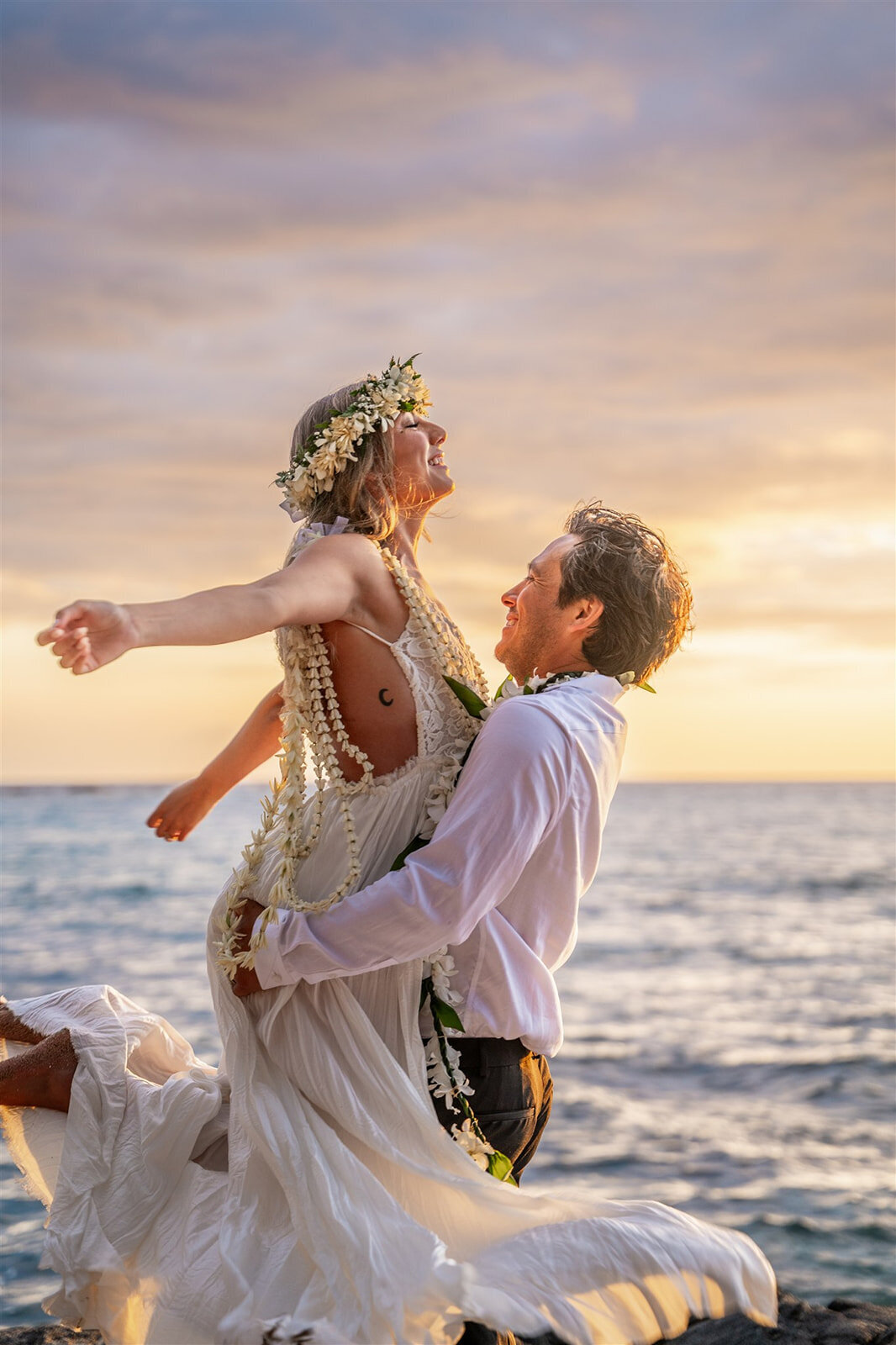 Couple dancing in the sunset on the beach by big island hawaii wedding photographer