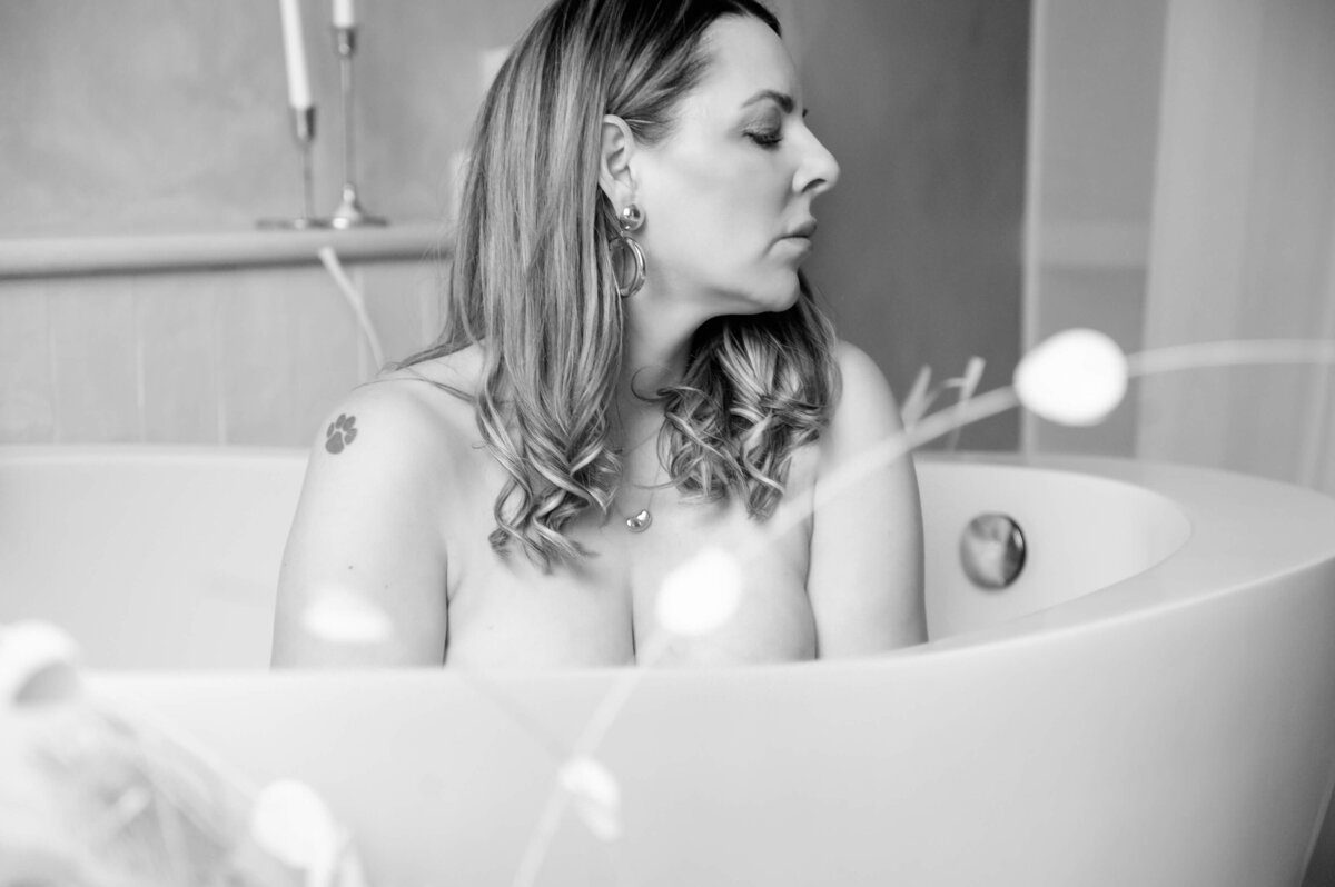 black and white photo of a woman in a bathtub  for her Hamilton boudoir photography session