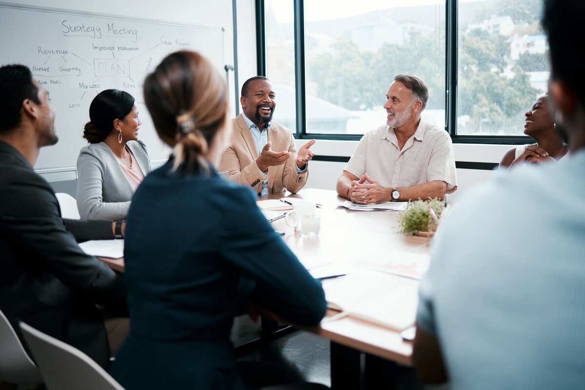 shot-of-a-group-of-businesspeople-listening-to-a-c-2023-11-27-05-27-01-utc