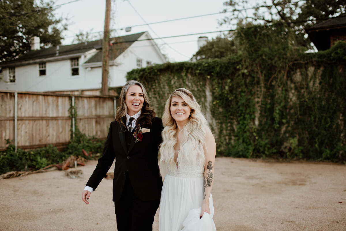 A happy candid of an LGBTQ+ couple at AvantGarden in Houston Texas. Captured by Fort Worth wedding photographer, Megan Christine Studio