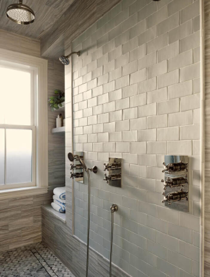 Boston Kitchen and Bath Designer designed a walk-in shower with light grey stone, ceramic tile from Waterworks, and Samuel Heath plumbing fixtures in a brownstone interior design project.