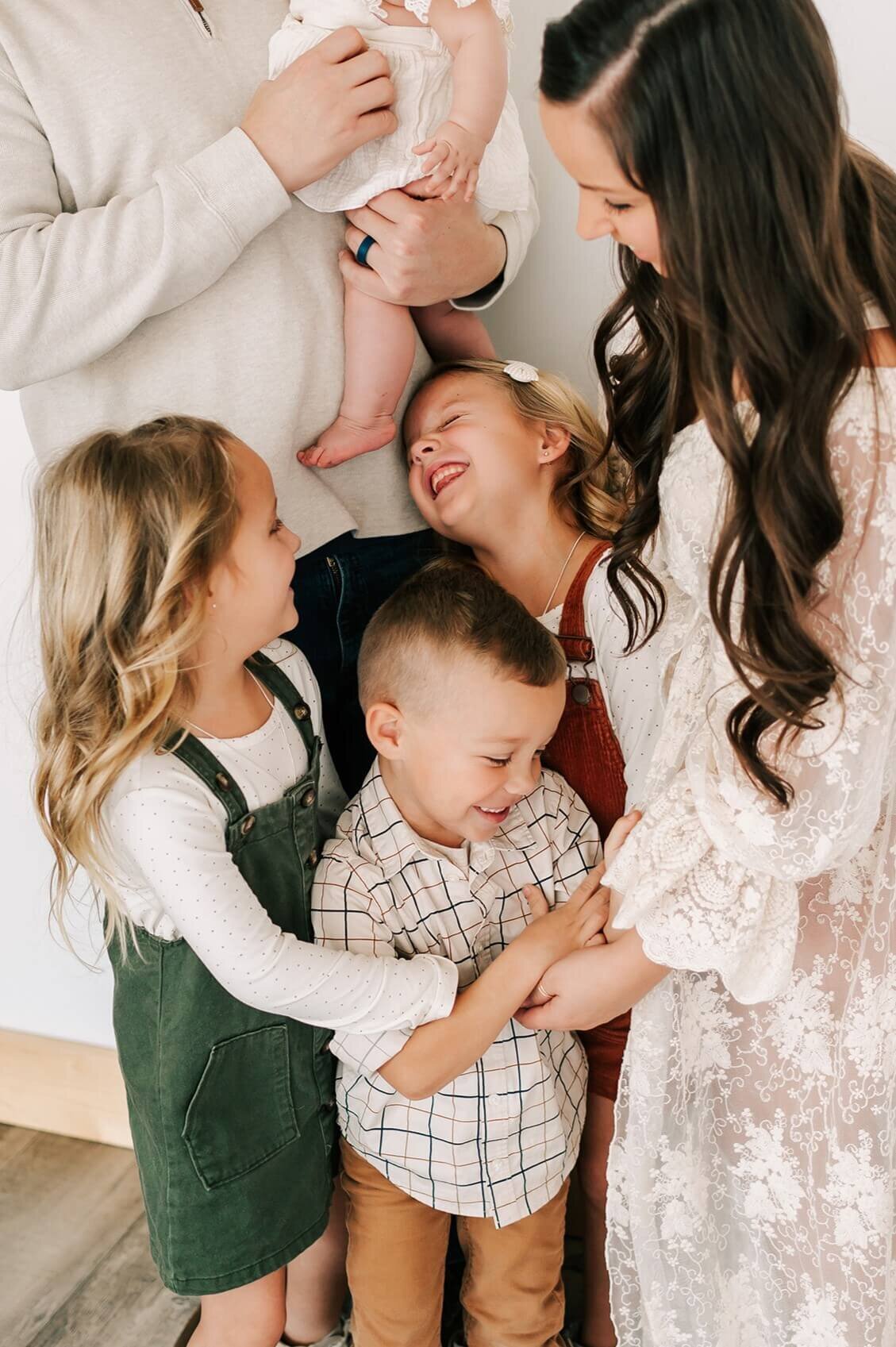 family laughing and hugging captured by Springfield MO family photographer Jessica Kennedy of The XO Photography