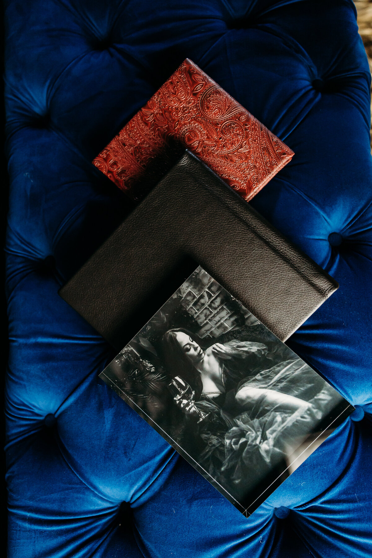 Boudoir photography keepsake albums on blue couch in Lubbock, Texas photographer in Amarillo TX
