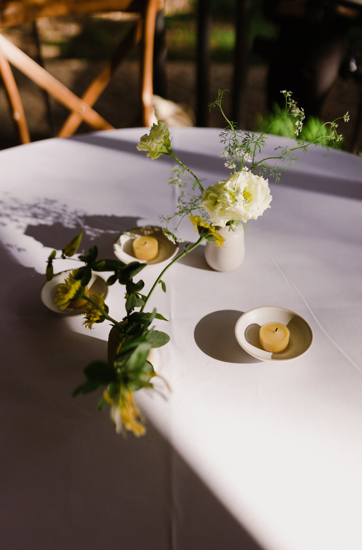 White florals and candles set upon a white table at Mattie's wedding venue in Austin