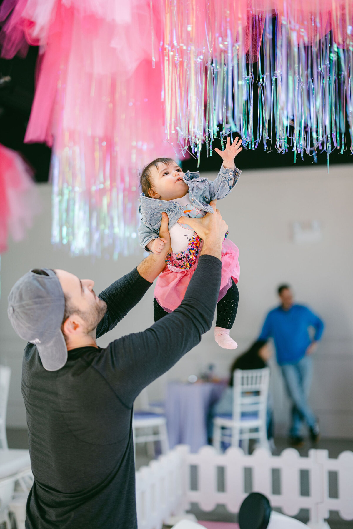 Colorful bounce house at a children’s birthday party venue, surrounded by vibrant balloons, playful decorations, and festive table settings, creating a fun and lively atmosphere