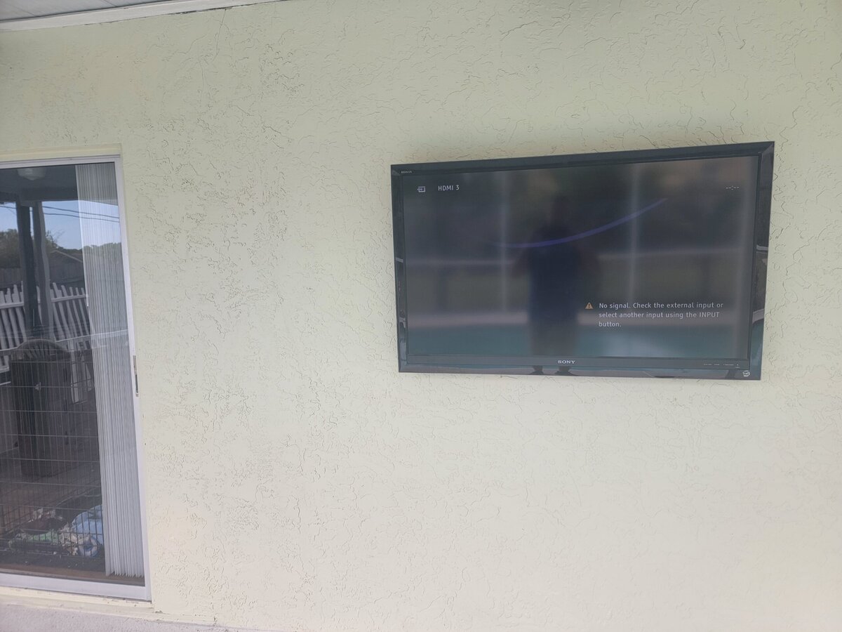 Tv mounted by pool in Tampa