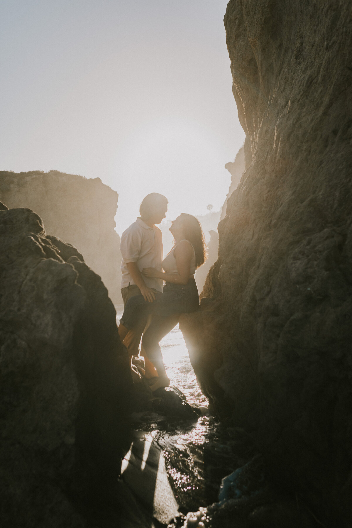Sunlit silhouette of a couple in a forested area, Indiana engagement photography.