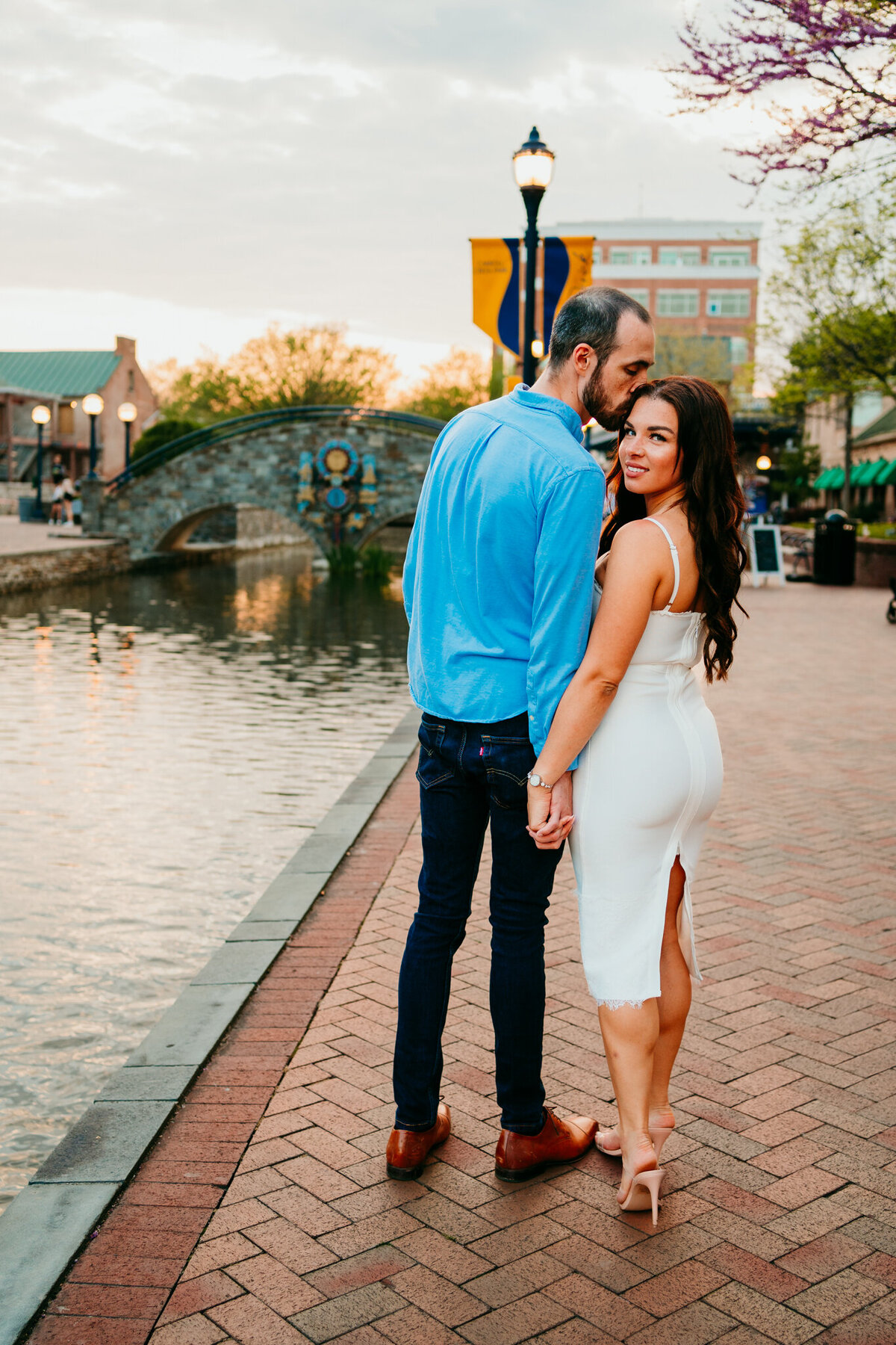 Romantic canal-side engagement with couple holding hands