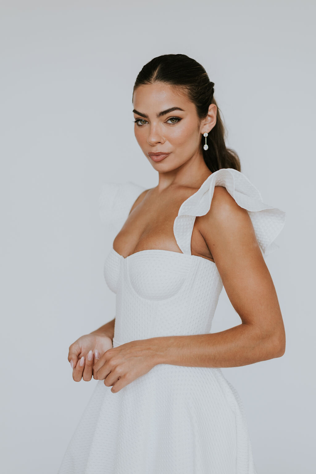 bridal stylist putting in veil
