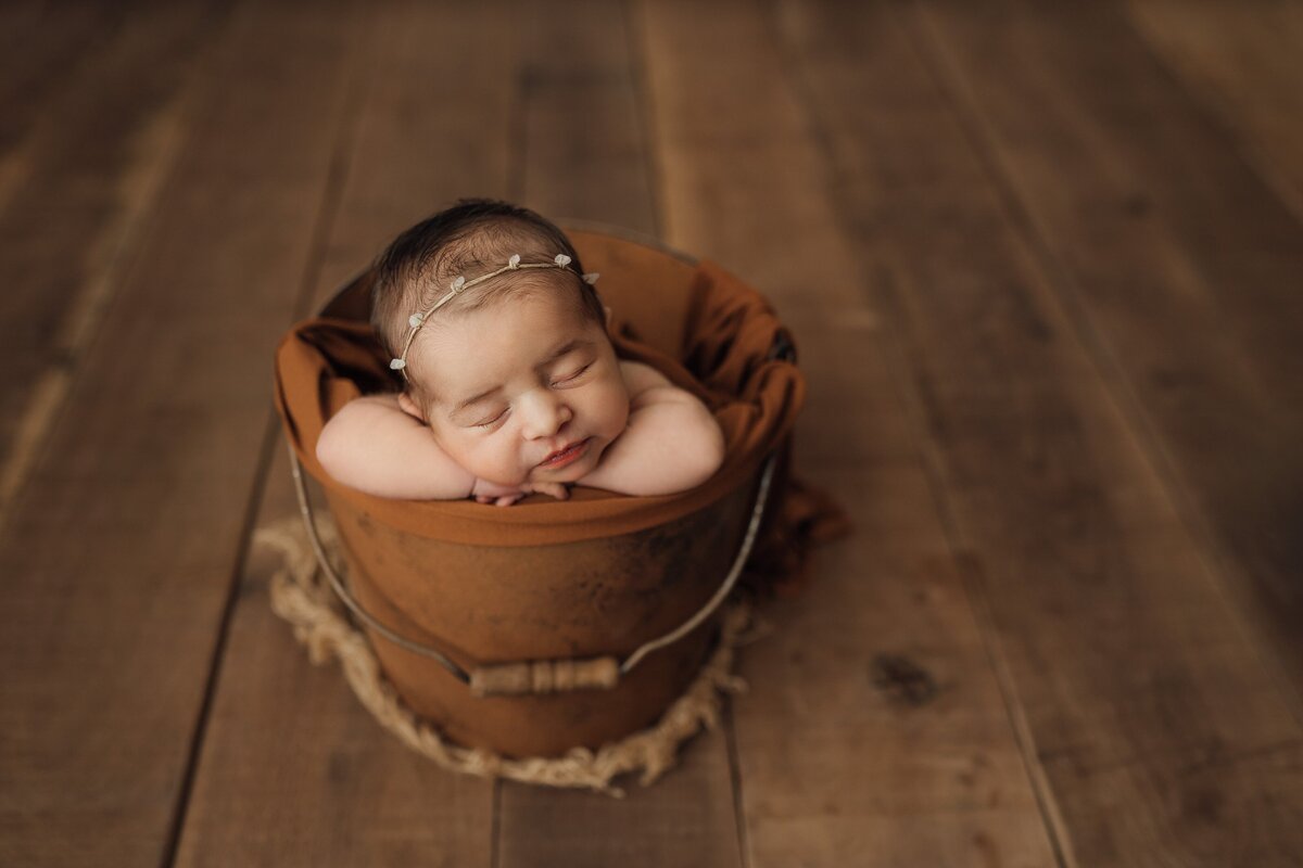 baby girl posed in bucket prop in clearwater studio