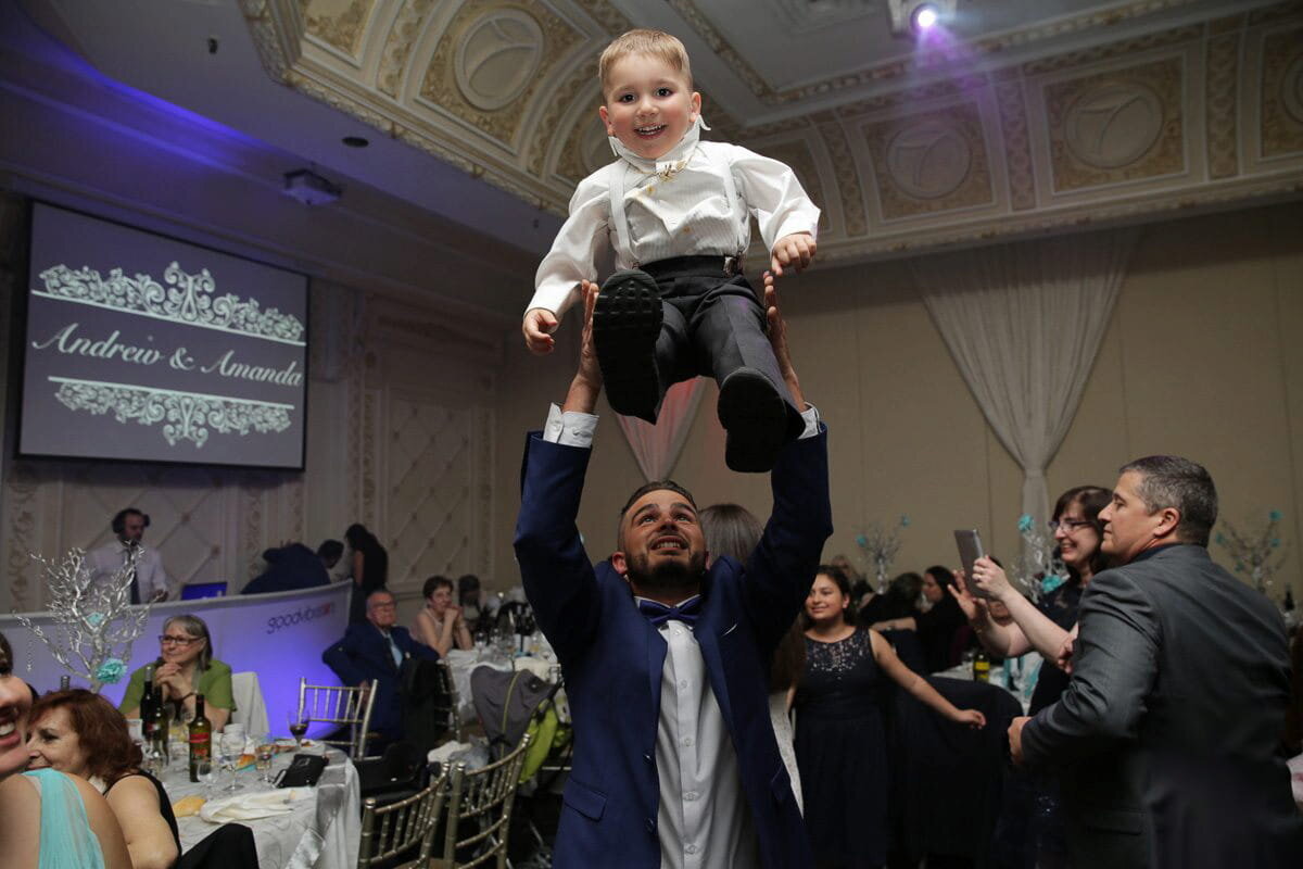 wedding-reception-child-lifted-guest-photo