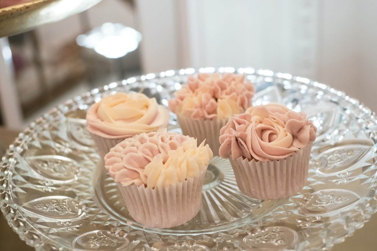 Lovely pink cup cakes sat on a crystal cake stand