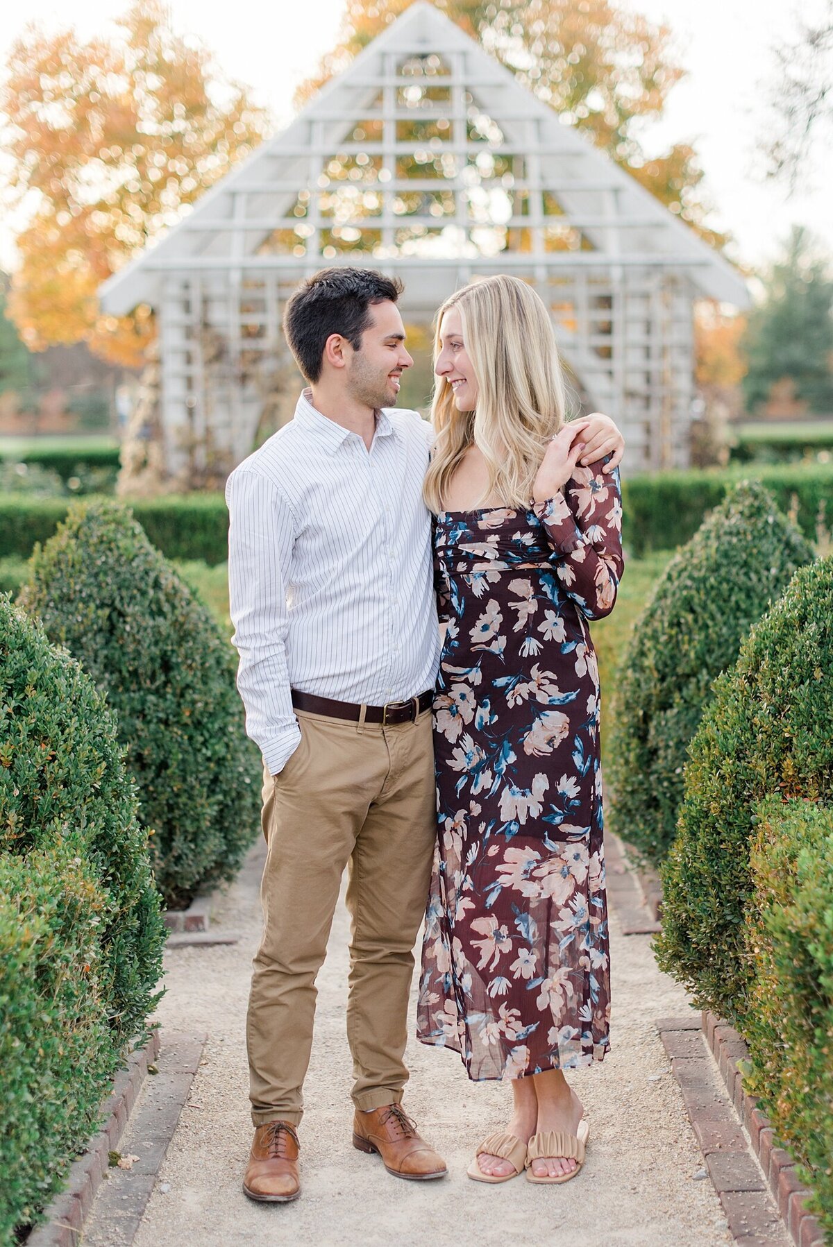 Couple smiling at each other on stone pathway during Columbus, Ohio engagement session taken by Ohio Wedding Photographer