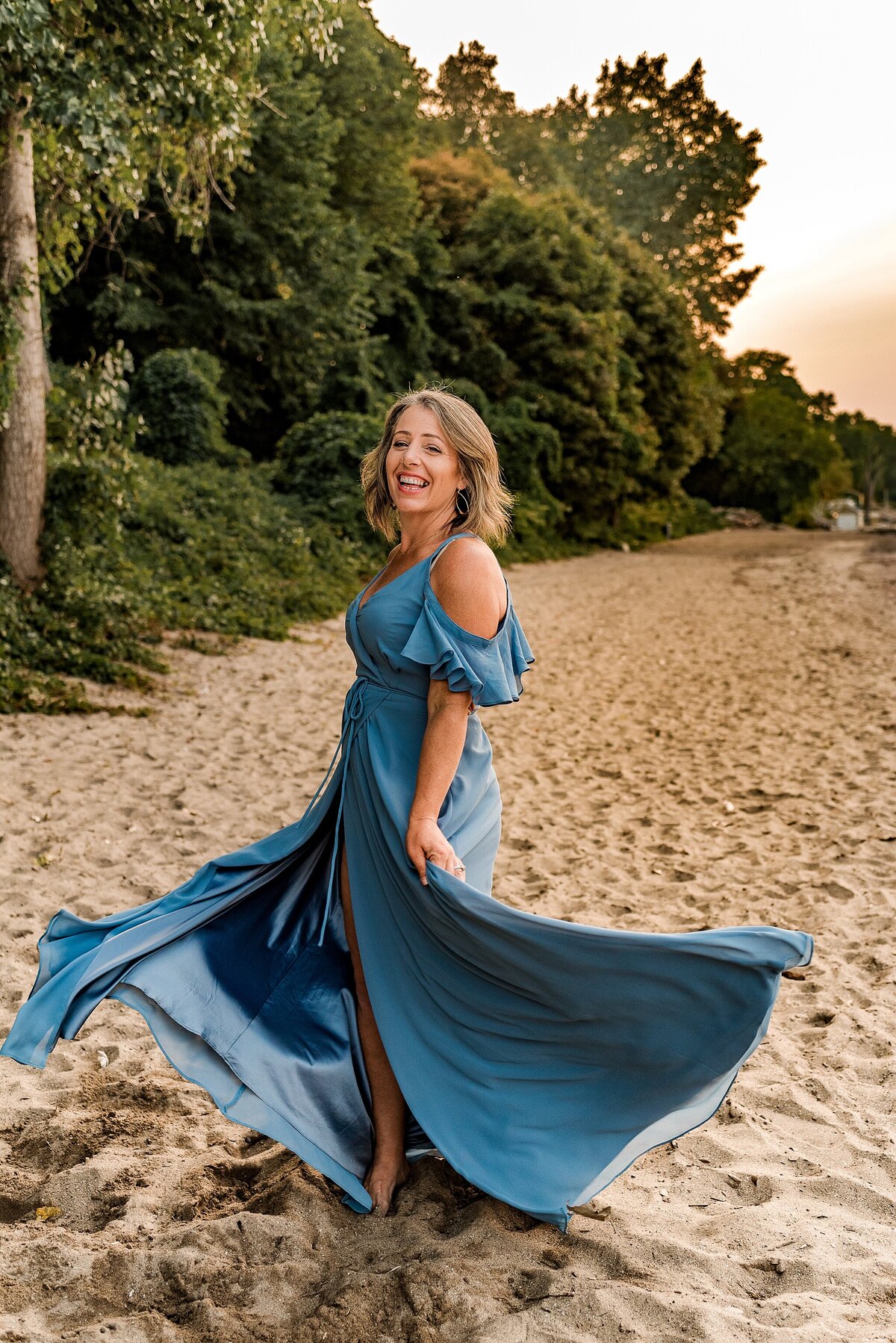 woman twirling on the beach