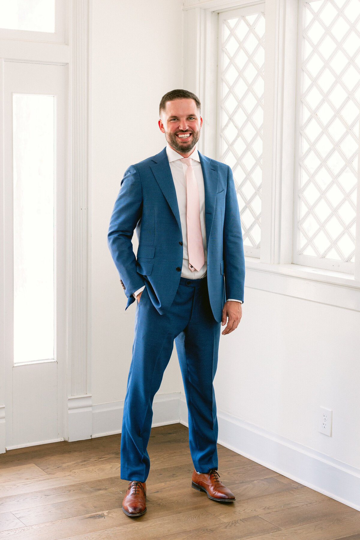 Groom in blue suit for wedding at The Grand Lady Austin