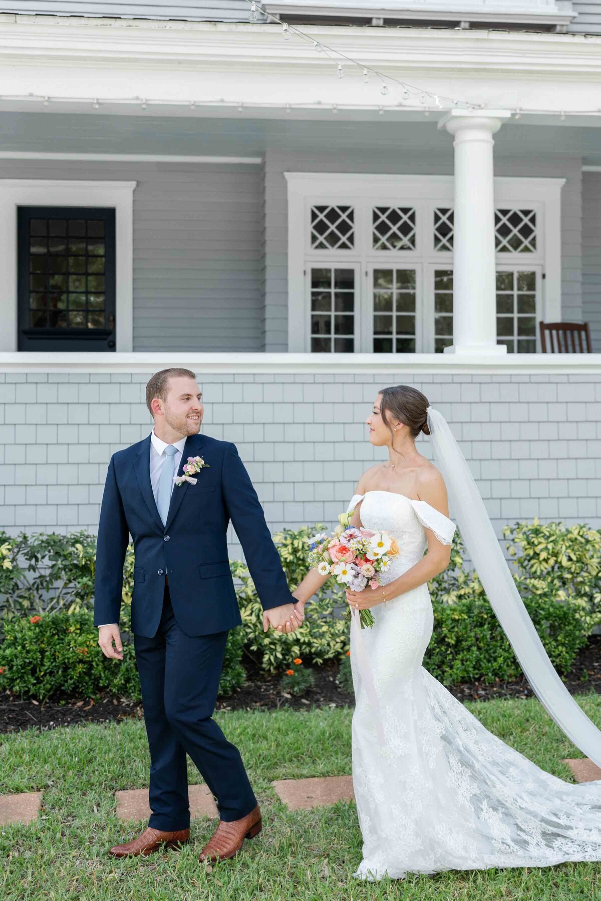 A bride and groom holding hands at their Tampa wedding at The Orlo House