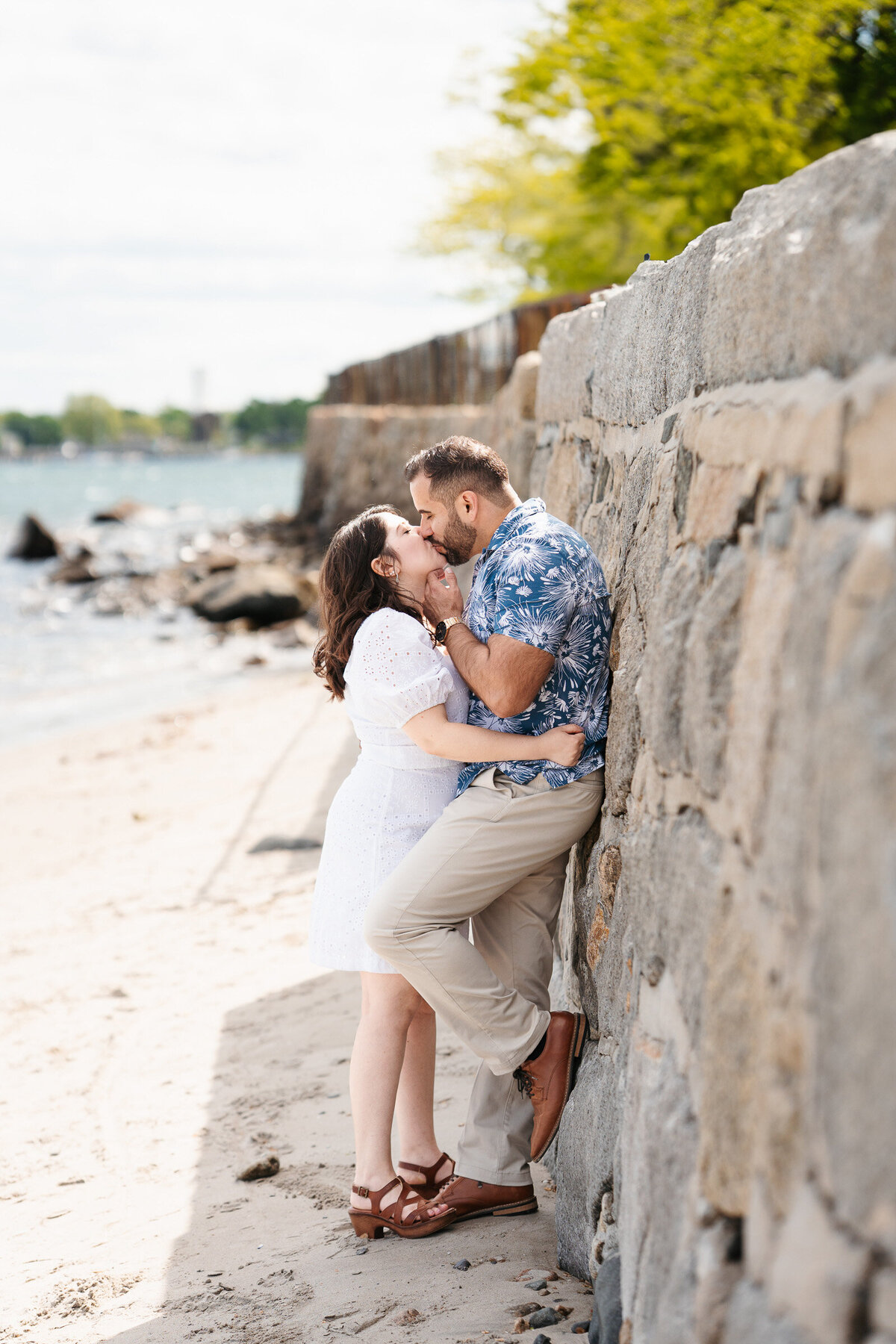 Romantic coastal engagement photos at Lynch Park with scenic shoreline views.
