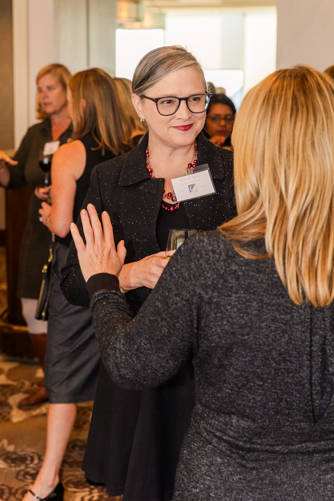 Business woman talking during an Atlanta networking event at the Atlanta Buckhead Club by event photographer Laure Photography