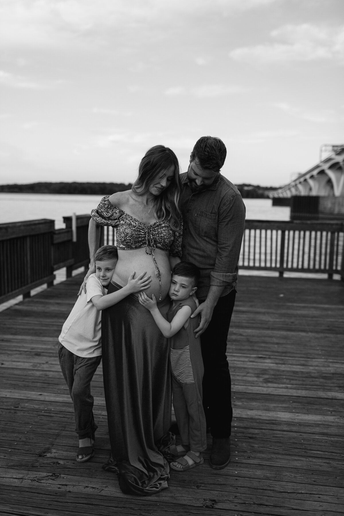 Black and white image of family on a dock