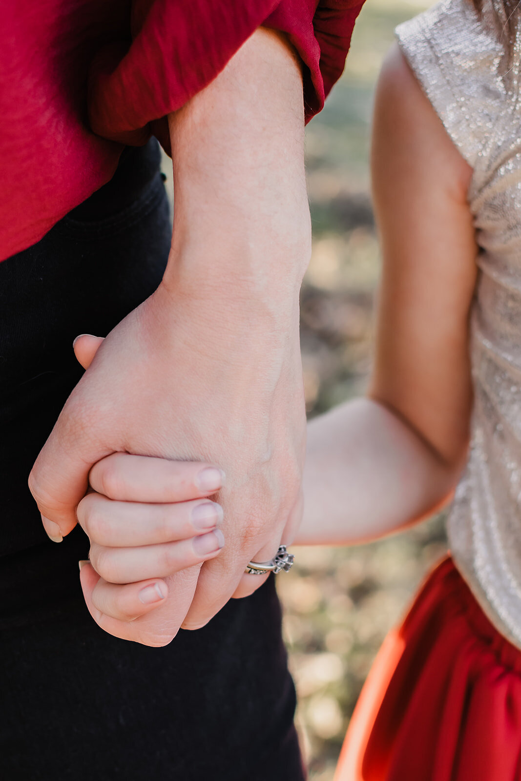 Mother and daughter embracing and holding hands.