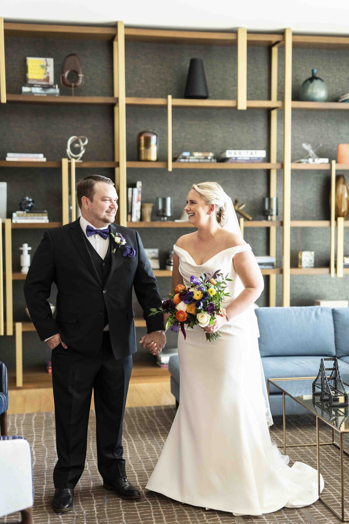 Bride and groom holding hands and smiling