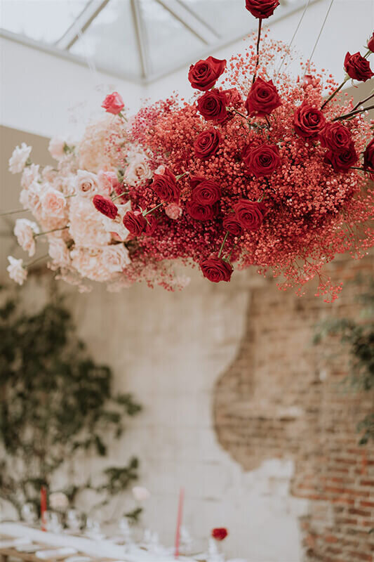 Flower cloud full of red, pink and white roses suspended from the ceiling