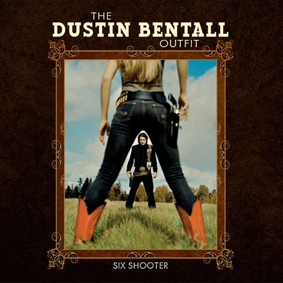 Album Cover The Dustin Bentall Outfit Title Six Shooter Artist in background between legs of girl wearing red cowboy boots in foreground both with hands near hips ready to draw