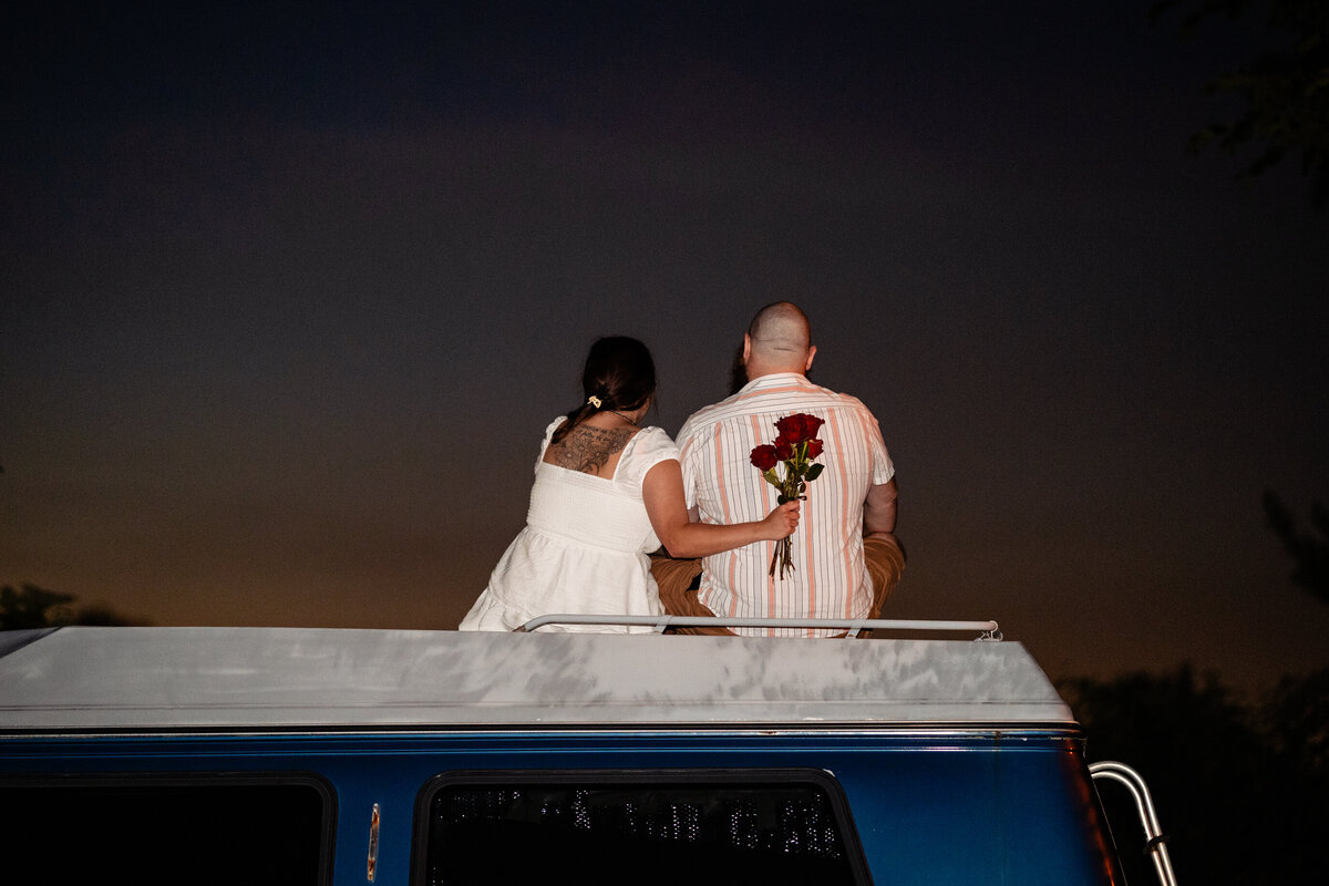 Couple on roof of camping van