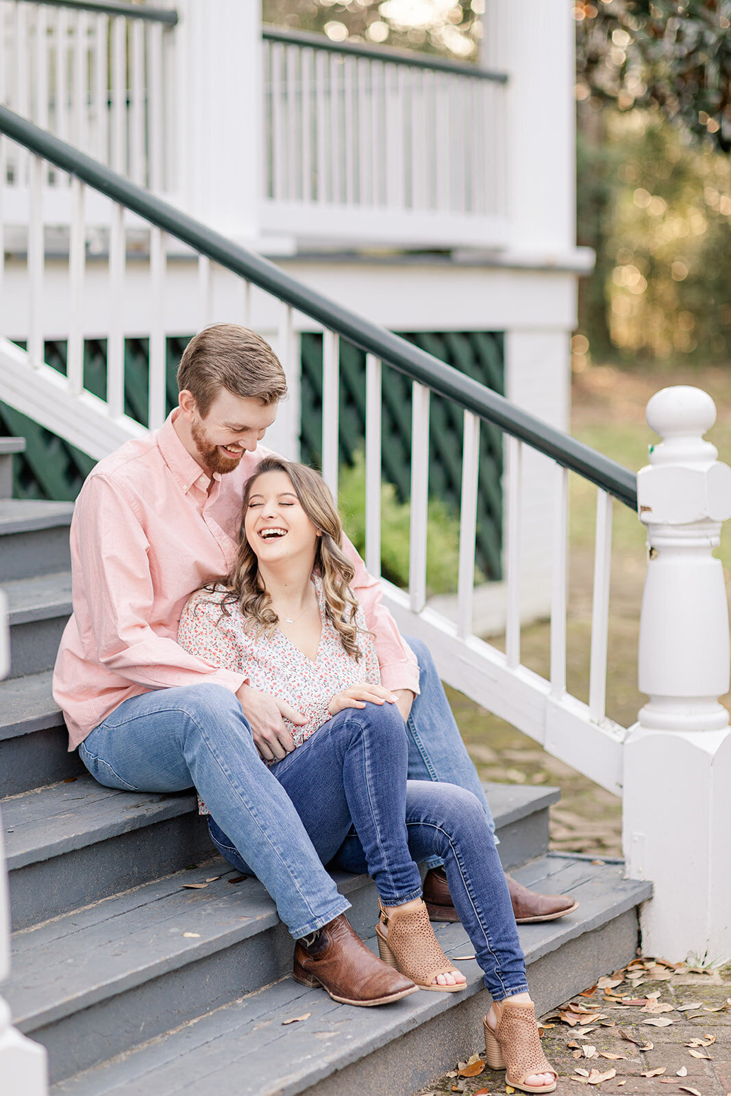 Engagement photo of couple sitting on steps at Springhill College; Mobile, AL