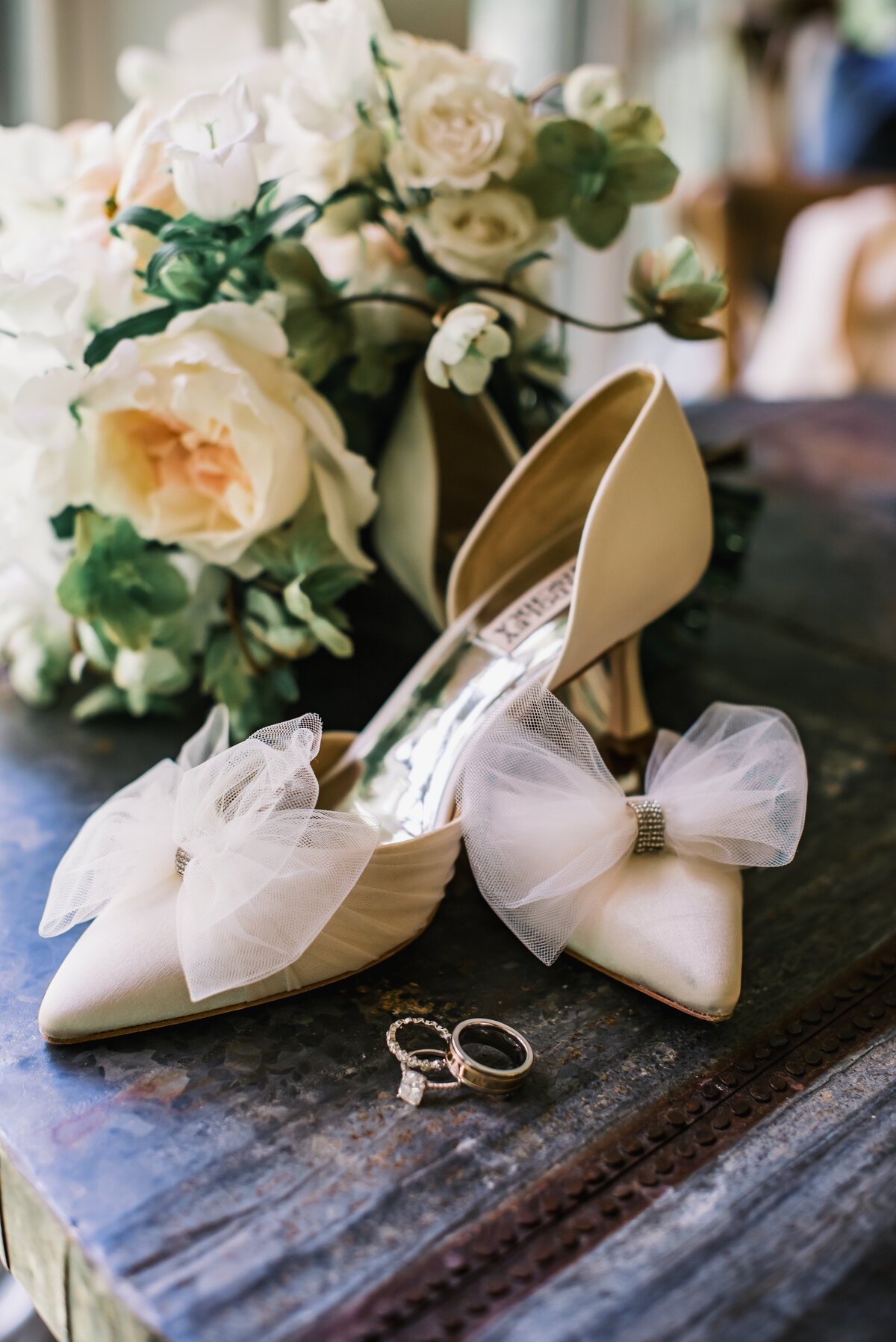 Bridal heels with tulle bows and wedding rings styled with cream florals at Old Edwards Inn wedding in Highlands, NC.
