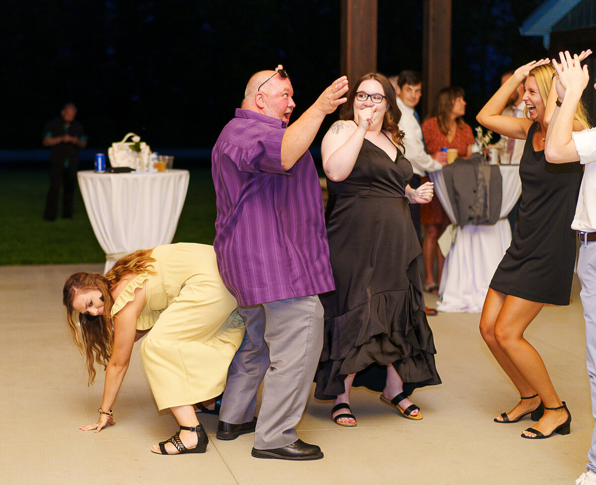 Guests laughing and dance at a wedding at Four Seasons Barn in Cardington, Ohio.