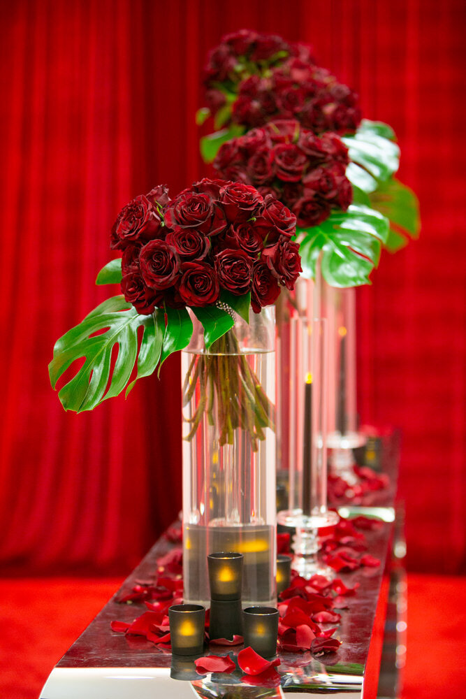 Bouquets of roses in tall vases