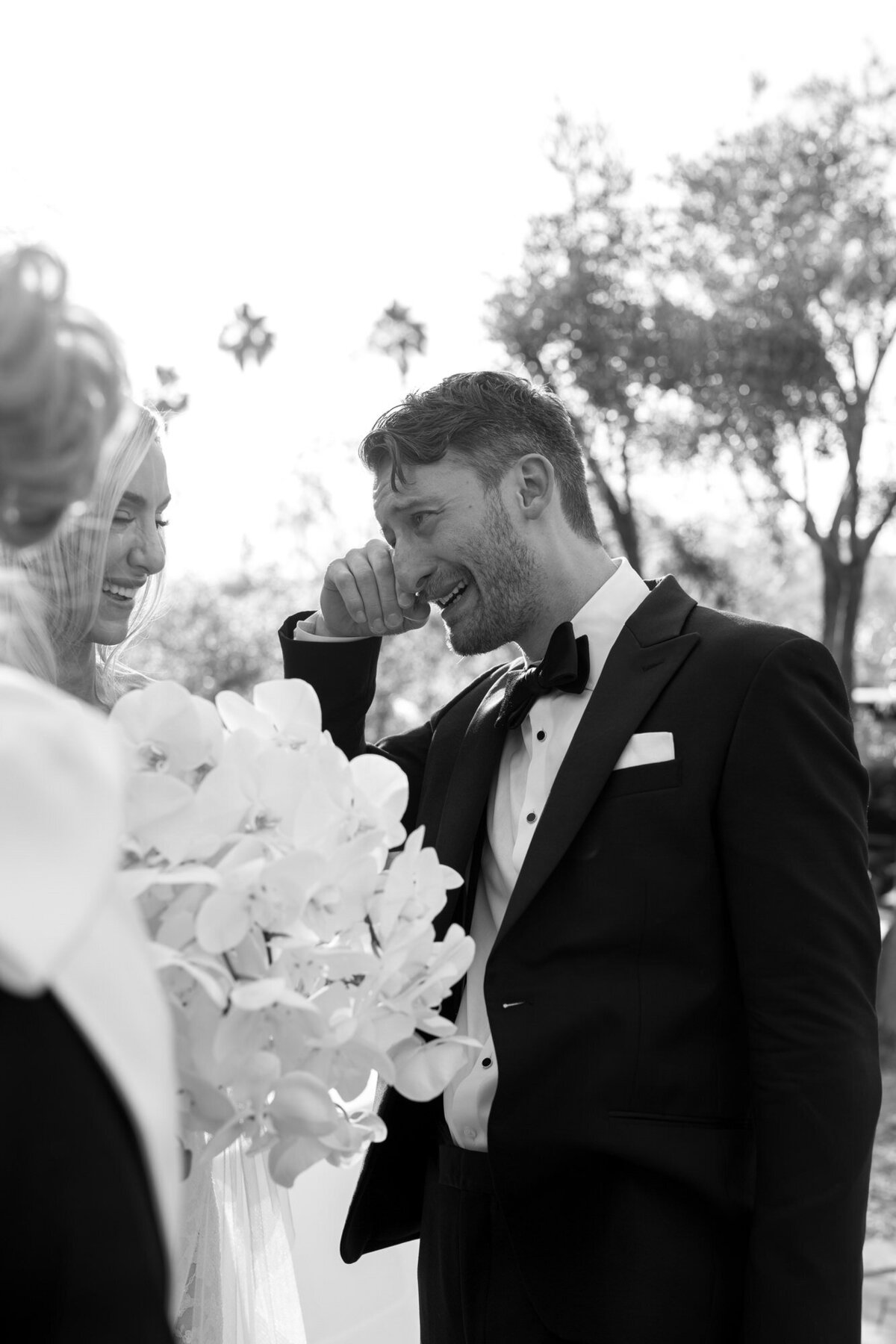 Candid moment of groom wiping tear at El Chorro