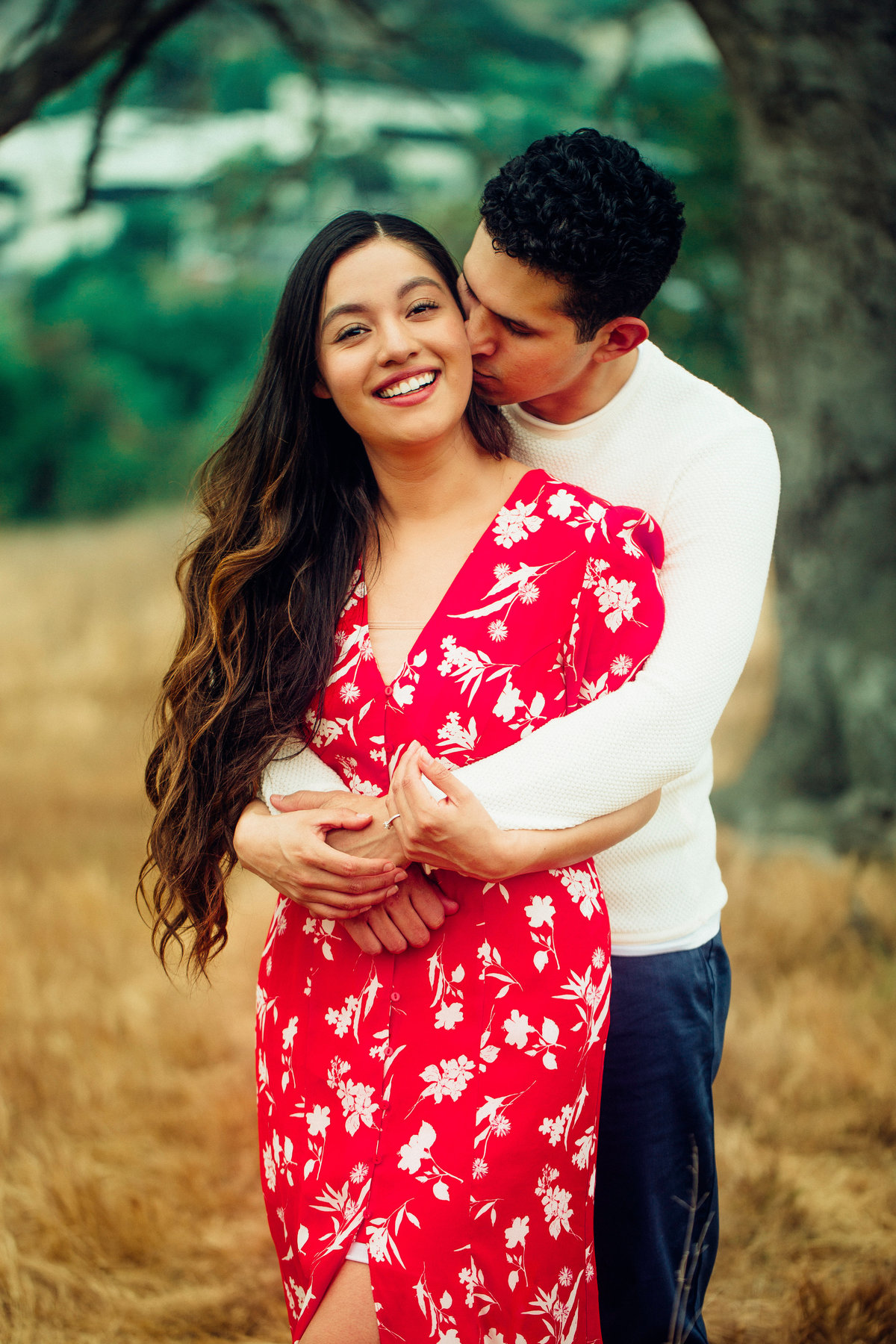 Engagement Photograph Of  Man In White Long Sleeves Hugging a Woman From The Back Los Angeles
