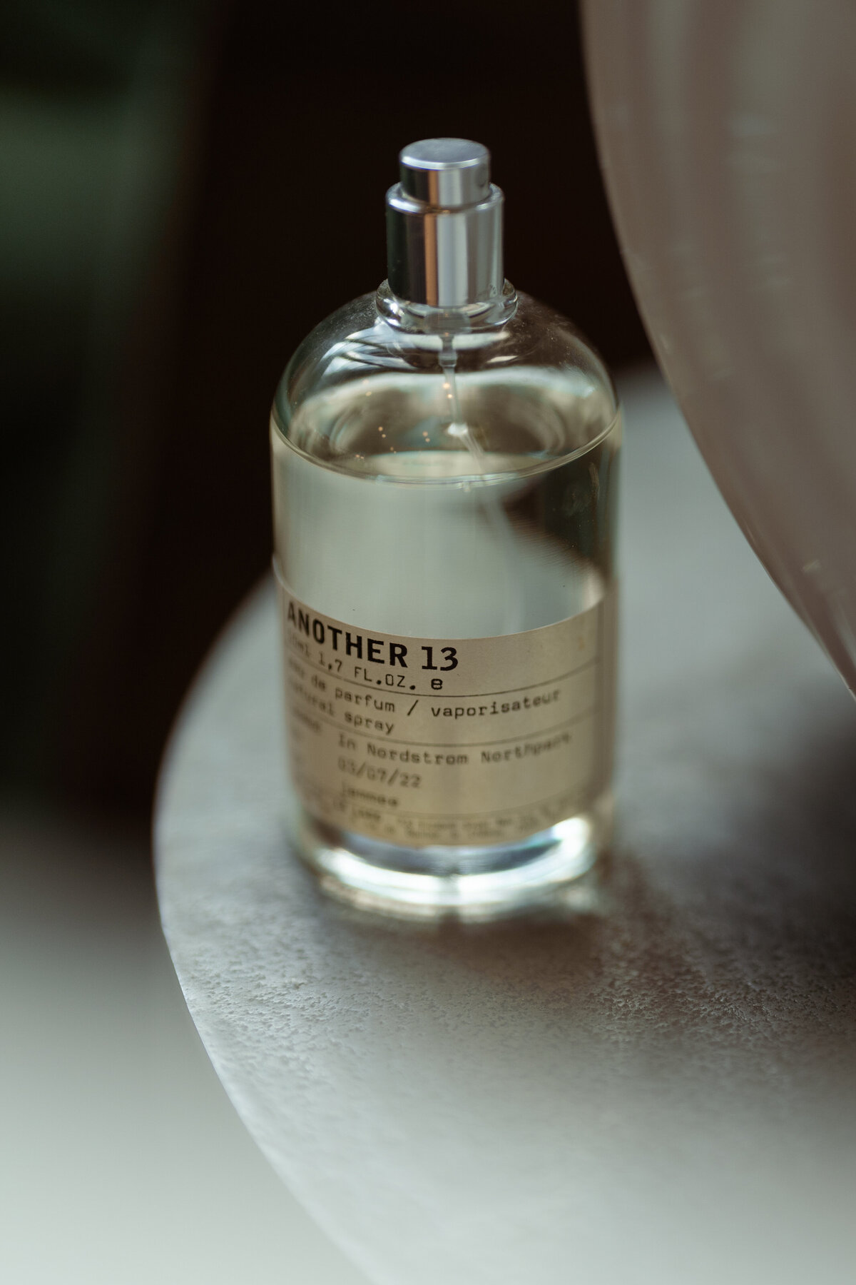A focused image of a perfume bottle, showcasing the personal touches that complete a bride's wedding day in Dallas.