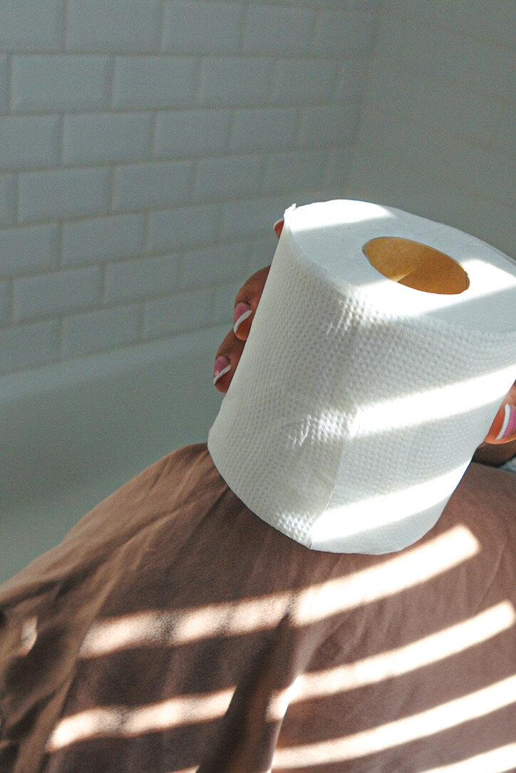 Toilet paper roll on knee