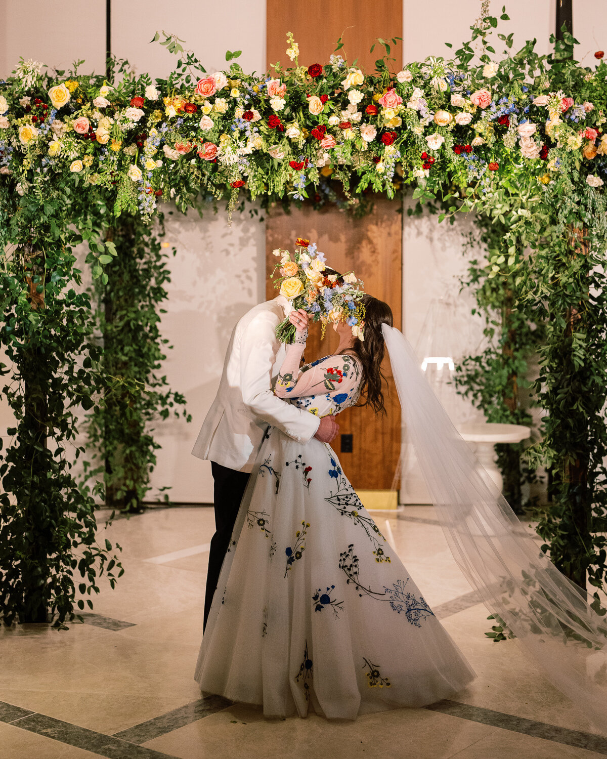 bride and groom kissing under chuppah