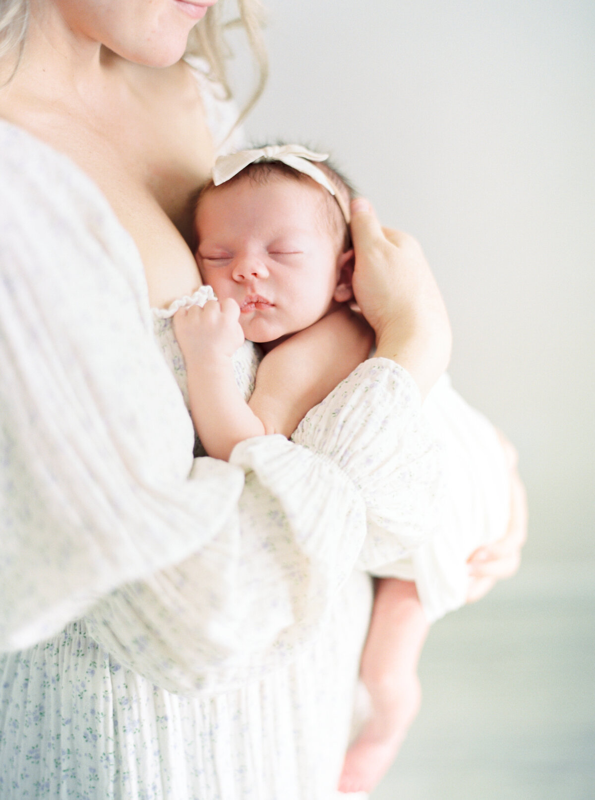 newborn baby girl in all white taken by newborn photography talia laird photography