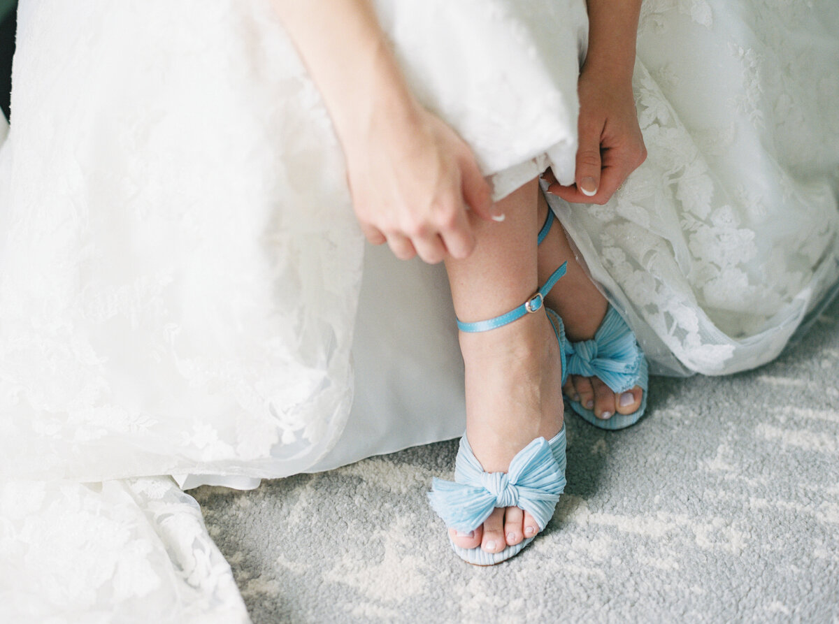 A beautiful capture of the bride's "something blue" wedding shoes, adding a touch of elegance and tradition to her special day, documented on film by Morgan Alysse, Louisiana film photographer.