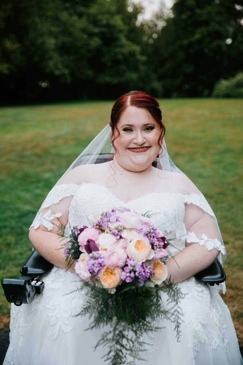 bride wearing a custom lace veil and holding a bouquet